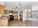 Open kitchen with stainless steel appliances and wood cabinets at 392 Dooley Dr, Henderson, NV 89015