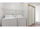 Laundry room with washer, dryer, and built-in shelving at 392 Dooley Dr, Henderson, NV 89015