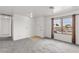 Living room featuring a large window, grey carpet, and entryway at 392 Dooley Dr, Henderson, NV 89015