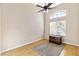 Bright bedroom with ceiling fan, large window, and hardwood floors at 3920 Red Trumpet Ct, North Las Vegas, NV 89081