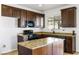 Kitchen with dark wood cabinets, granite countertops, and an island at 3920 Red Trumpet Ct, North Las Vegas, NV 89081