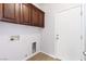 Laundry room with wood cabinets and exterior access at 3920 Red Trumpet Ct, North Las Vegas, NV 89081