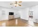 Living room with laminate flooring, a large TV, and access to another room at 3920 Red Trumpet Ct, North Las Vegas, NV 89081