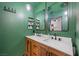 Modern bathroom with double vanity and green walls at 4039 Halfmoon Bay Dr, Las Vegas, NV 89115