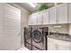 Laundry room with washer, dryer, and ample cabinet space at 4417 S Grand Cypress Way, Pahrump, NV 89061