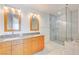 Modern bathroom with double sinks, granite counters, and a glass shower at 4575 Dean Martin Dr # 1108, Las Vegas, NV 89103