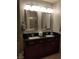 Bathroom with double sinks and dark wood cabinets at 4575 Dean Martin Dr # 2001, Las Vegas, NV 89103