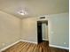 Well-lit bedroom with wood-look floors and access to bathroom at 5650 E Sahara Ave # 2029, Las Vegas, NV 89142