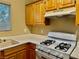 Kitchen with light wood cabinets, white appliances, and a gas cooktop at 5650 E Sahara Ave # 2029, Las Vegas, NV 89142