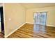 Spacious living room featuring wood-look floors and sliding glass door at 5650 E Sahara Ave # 2029, Las Vegas, NV 89142