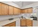 Kitchen with wood cabinets and a corner sink at 5728 Palma Del Sol Way, Las Vegas, NV 89130