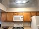 Kitchen with microwave, stove and wooden cabinets at 5728 Palma Del Sol Way, Las Vegas, NV 89130