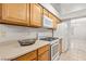 Kitchen with wood cabinets, gas range, and white appliances at 5728 Palma Del Sol Way, Las Vegas, NV 89130