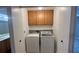 Well-lit laundry room with washer and dryer and cabinets at 5728 Palma Del Sol Way, Las Vegas, NV 89130