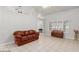 Living room with brown leather couch and tiled floor at 5728 Palma Del Sol Way, Las Vegas, NV 89130