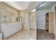 Bathroom with double vanity, large closet, and mirror at 5892 Rothbury Ave, Las Vegas, NV 89141