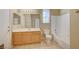 Clean bathroom with light wood cabinets and tub at 5892 Rothbury Ave, Las Vegas, NV 89141