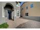 Brick paved walkway to the front entrance with columns and a dark door at 5892 Rothbury Ave, Las Vegas, NV 89141