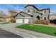 Beautiful two-story home with a landscaped front yard and two-car garage at 5892 Rothbury Ave, Las Vegas, NV 89141