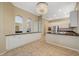 Kitchen features granite countertops and white cabinets at 5892 Rothbury Ave, Las Vegas, NV 89141