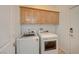 Laundry room with washer, dryer, and cabinets at 5892 Rothbury Ave, Las Vegas, NV 89141