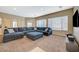 Spacious living room with large sectional sofa and carpeted floor at 5892 Rothbury Ave, Las Vegas, NV 89141