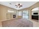 Living room with fireplace, built-in shelves, and sliding doors to patio at 5892 Rothbury Ave, Las Vegas, NV 89141