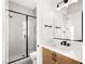 Modern bathroom with a walk-in shower and wood vanity at 6385 Leeland Ct, Las Vegas, NV 89149