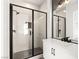 Bathroom with black framed glass shower and gray tile at 6385 Leeland Ct, Las Vegas, NV 89149