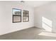 Simple bedroom with neutral walls and grey tile floors at 6385 Leeland Ct, Las Vegas, NV 89149