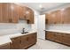 Laundry room with wood cabinets and quartz countertops at 6385 Leeland Ct, Las Vegas, NV 89149