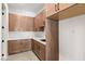 Laundry room with light wood cabinets and quartz countertops at 6385 Leeland Ct, Las Vegas, NV 89149