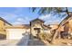 Single-story house with a beige exterior and attached garage at 6452 Casamar St, North Las Vegas, NV 89086