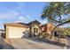 One-story house with a two-car garage and desert landscaping at 6452 Casamar St, North Las Vegas, NV 89086