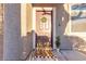 Inviting front door entry with a wreath and welcome mat at 6452 Casamar St, North Las Vegas, NV 89086