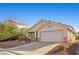 Single story home with two car garage and desert landscaping at 6501 Grand Oaks Dr, Las Vegas, NV 89156