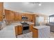 Kitchen with wood cabinets, stainless steel appliances, and an island at 6501 Grand Oaks Dr, Las Vegas, NV 89156