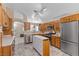 Spacious kitchen with island, stainless steel appliances, and wood cabinets at 6501 Grand Oaks Dr, Las Vegas, NV 89156