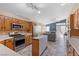 Kitchen with wood cabinets, stainless steel appliances, and island, open to Gathering room at 6501 Grand Oaks Dr, Las Vegas, NV 89156