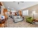 Comfortable living area with grey sofa and green accent chair at 6501 Grand Oaks Dr, Las Vegas, NV 89156