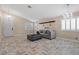 Living room with tiled floors, gray sofa, and entryway view at 6501 Grand Oaks Dr, Las Vegas, NV 89156