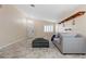 Living room with tiled floors, gray sofa, and entryway view at 6501 Grand Oaks Dr, Las Vegas, NV 89156