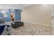 Living room with tiled floors, gray sofa, and access to other areas of the home at 6501 Grand Oaks Dr, Las Vegas, NV 89156