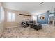 Living room with tiled floors, gray sofa, and a view into the kitchen at 6501 Grand Oaks Dr, Las Vegas, NV 89156