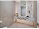 Elegant bathroom boasts a floating vanity and textured wall tiles at 665 Overlook Rim Dr, Henderson, NV 89012