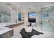 Bright bathroom with a soaking tub, dual vanities, and a glass-enclosed shower at 665 Overlook Rim Dr, Henderson, NV 89012