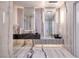 Modern bathroom featuring marble walls, floor-to-ceiling mirrors, and sleek fixtures at 665 Overlook Rim Dr, Henderson, NV 89012