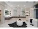 Elegant bathroom featuring marble accents, dual sinks, and a soaking tub at 665 Overlook Rim Dr, Henderson, NV 89012