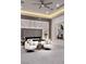 Comfortable bedroom with carpet, lounge chairs, and accent lighting at 665 Overlook Rim Dr, Henderson, NV 89012