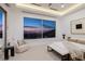 Luxurious bedroom with a large window showcasing city views and elegant, modern furnishings at 665 Overlook Rim Dr, Henderson, NV 89012